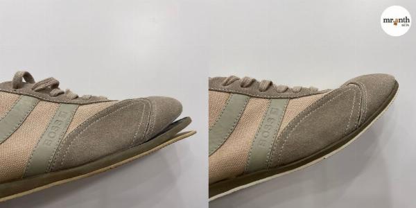 Một người thợ sửa giày đang tỉ mỉ phục hồi đế giày da trong tiệm, thể hiện dịch vụ bảo dưỡng sửa chữa giày Tân Bình chuyên nghiệp.